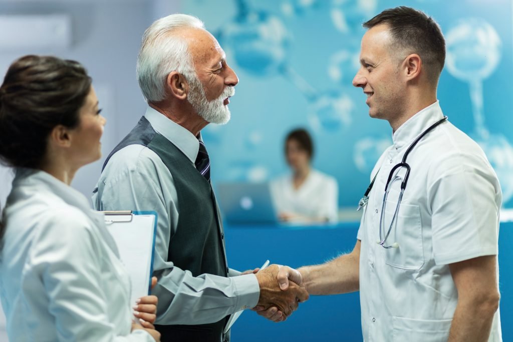 patient and doctor shake hand after endoscopy treatment